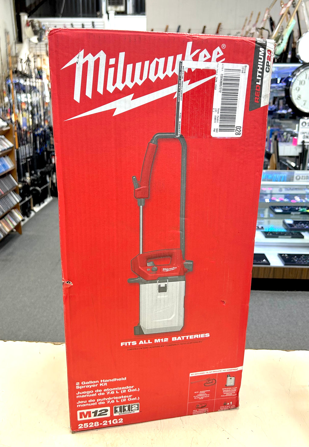 Red Milwaukee tool box with a power tool on a store shelf background