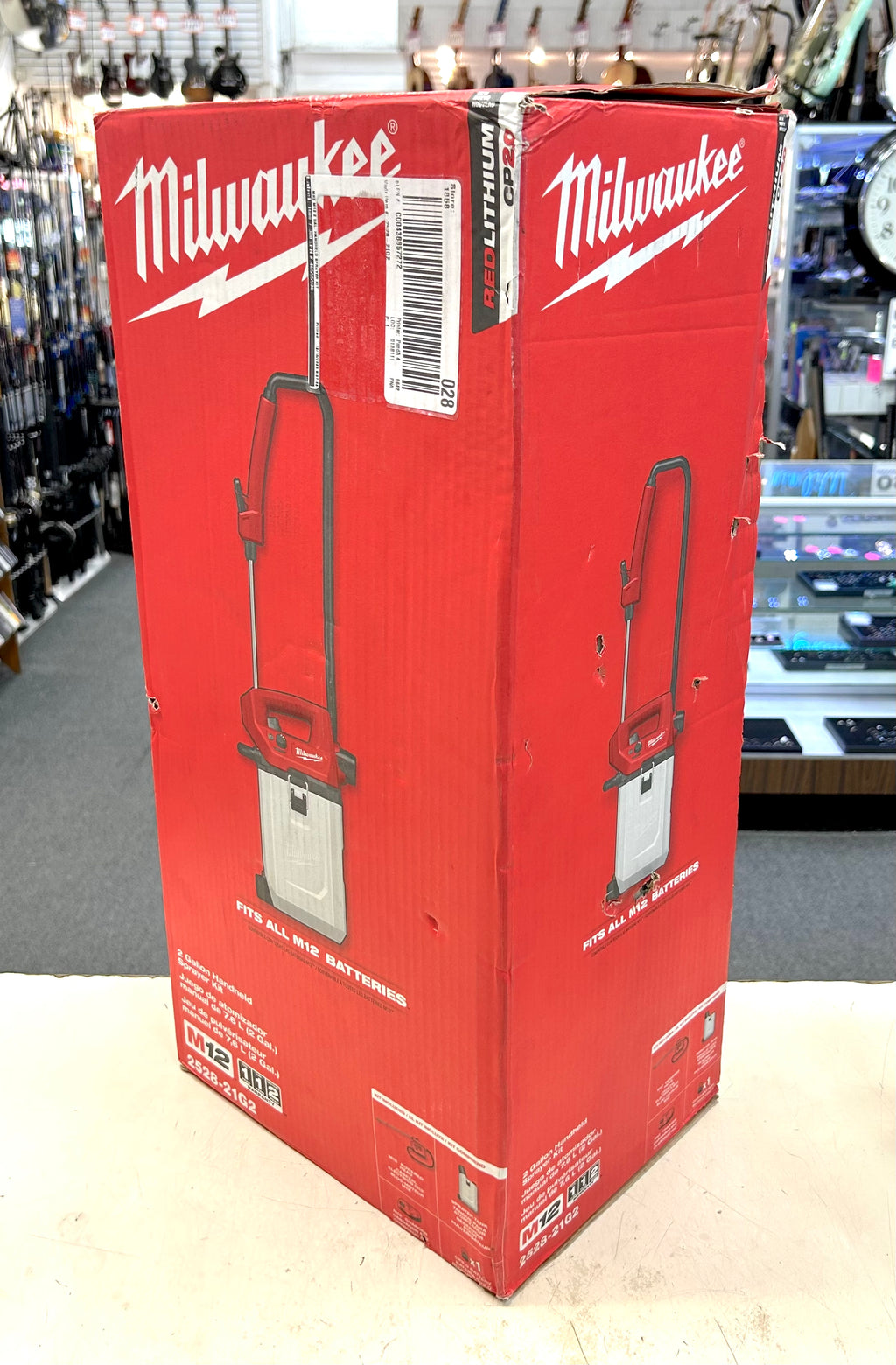 Red Milwaukee tool box with a power washer on a store shelf