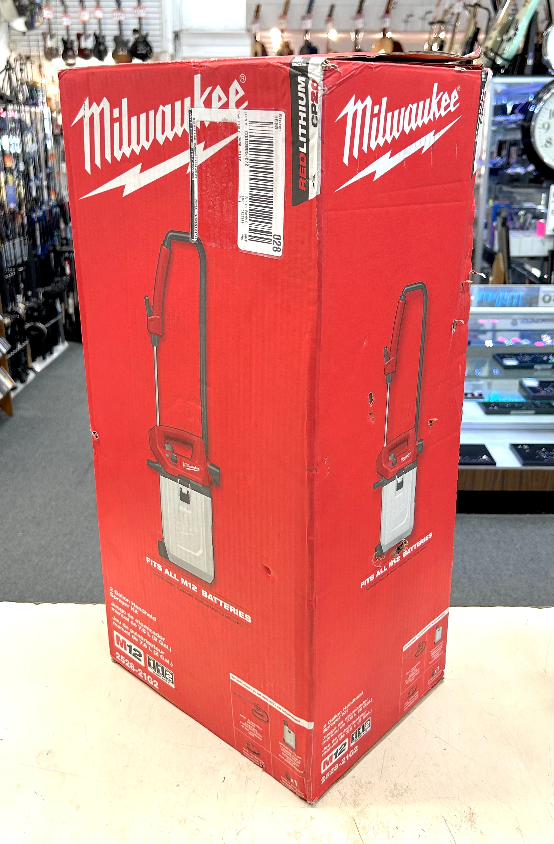 Red Milwaukee tool box with a power washer on a store shelf
