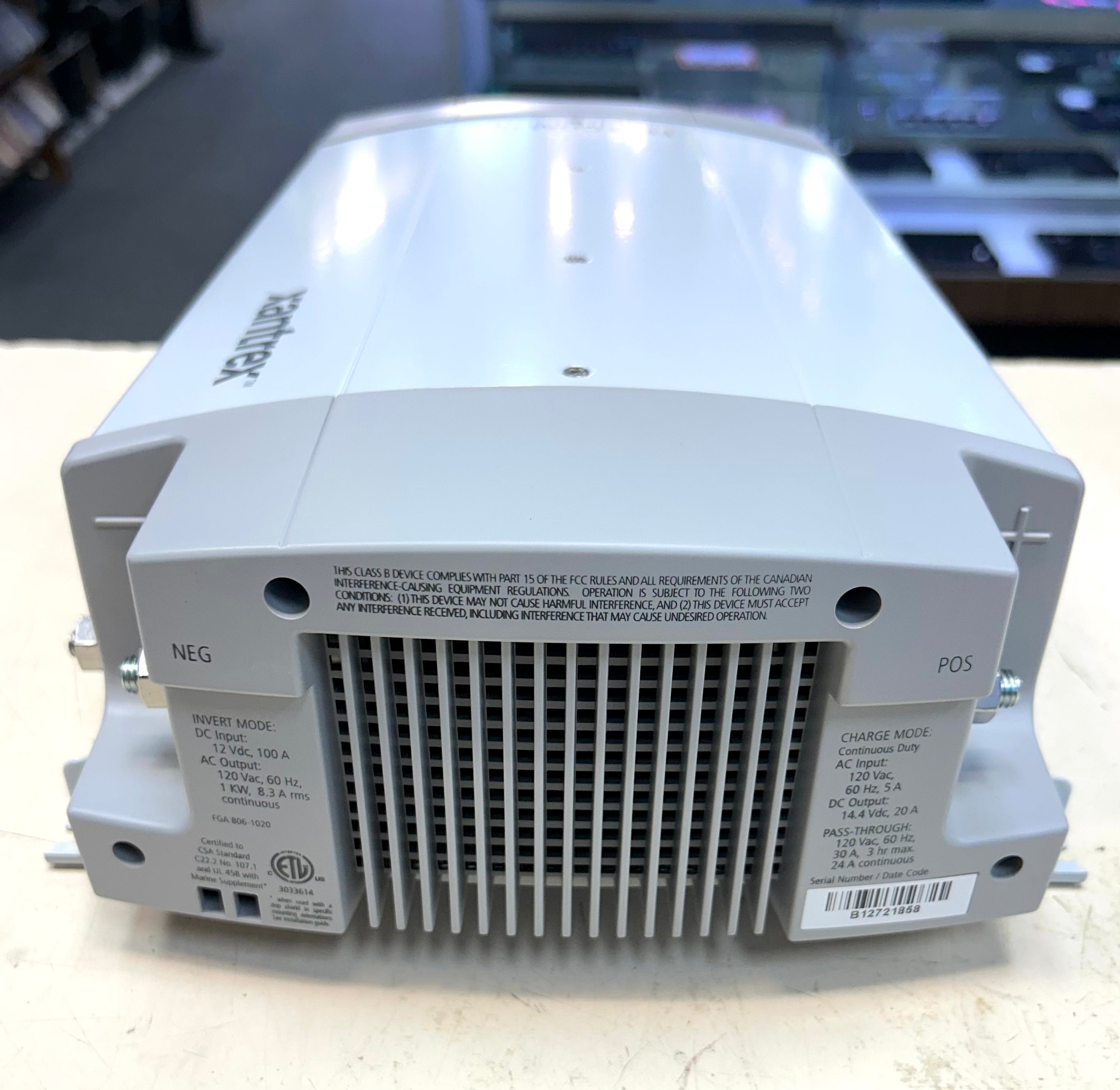 Back view of a power supply unit with branding on a blurred background